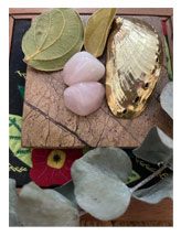 A wooden board with leaves and stones on it